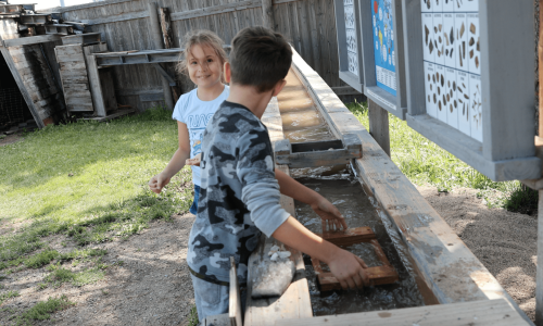 Happy children gemstone panning at 1880 Town